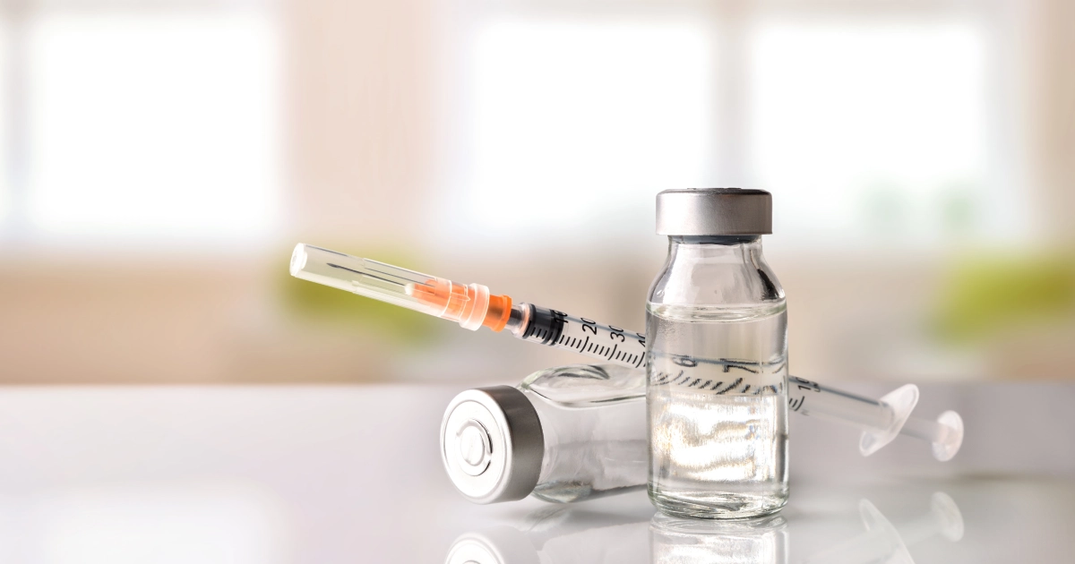 Vial of clear liquid and syringe representing NAD+ therapy in Austin, TX